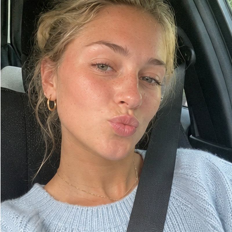 Car selfie pulling a face, bright flash lit digicam style photo