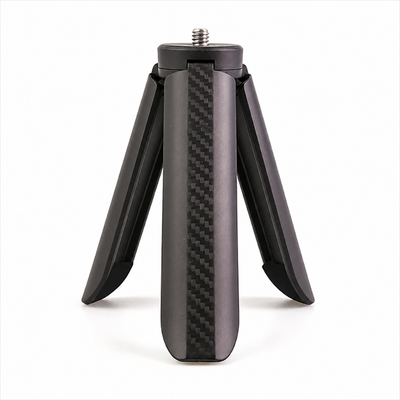 A black carbon fiber mini tripod with a textured weave pattern on the center leg and a threaded screw base, shown on a clean white background.