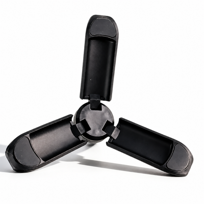 A black three-spoke plastic accessory, likely a mounting bracket or clip, shown open on a white background.
