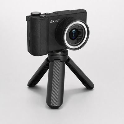 DayRoll mini camera tripod holding a black 4K compact camera, legs open on a plain background