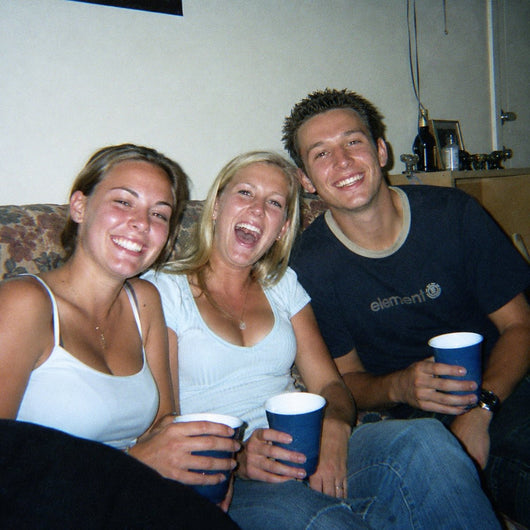 Friends with drinks at a house get-together, shot on a DayRoll with the warm LED fill light